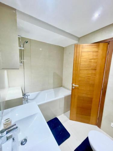 a bathroom with a sink and a toilet and a tub at Airport Luxury Residence Taj collection 1 in Casablanca