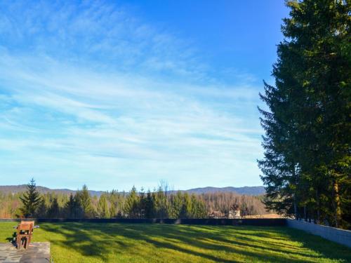 a park with a bench in the middle of a field at Chalet Makov Hrib by Interhome in Tršće