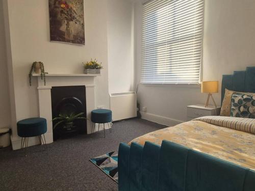 a living room with a bed and a fireplace at Glams one bedroom apartment in Wolverhampton