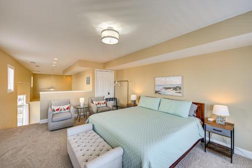 a bedroom with a large bed and a chair at 'Phoenix Nest' South Haven Condo: River View! in South Haven