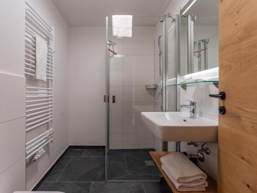 a bathroom with a sink and a shower at Lärchenhof Top 01 in Mauterndorf