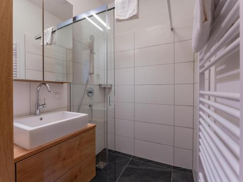 a bathroom with a sink and a shower at Lärchenhof Top 101 in Mauterndorf