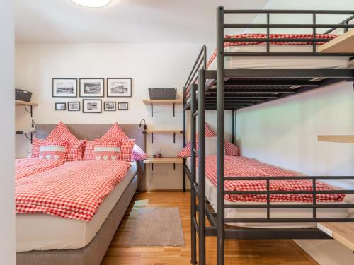 a bedroom with two bunk beds and a ladder at Lungau Residence in Tamsweg