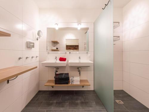 a bathroom with two sinks and a mirror at Lungau Residence in Tamsweg