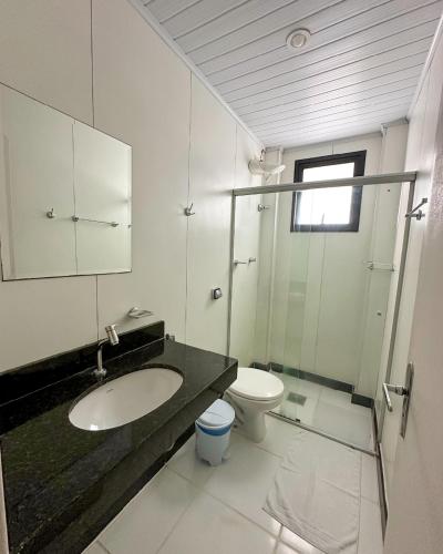 a bathroom with a sink and a toilet at Real Hotel in Sete Lagoas