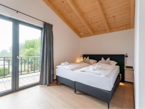 a bedroom with a bed and a balcony at Obermöschach 5A in Obermöschach