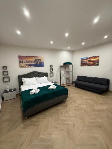 a bedroom with a large bed and a couch at HV Carbonara 123 in Naples