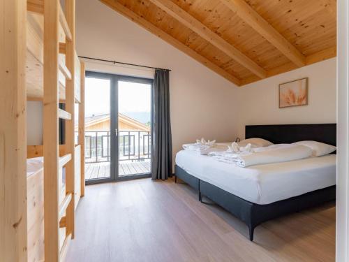 a bedroom with a bed and a large window at Obermöschach 7A in Obermöschach