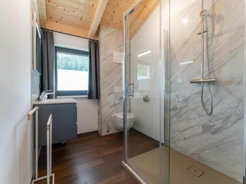 a bathroom with a glass shower and a toilet at Obermöschach 6A in Obermöschach