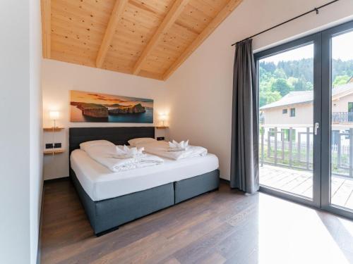 a bedroom with a bed and a large window at Obermöschach 6A in Obermöschach