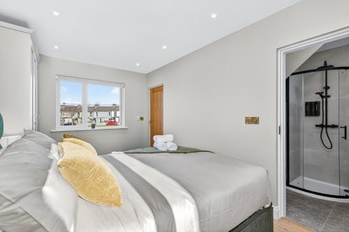 a white bedroom with a large bed and a window at Martin Savage in Sligo