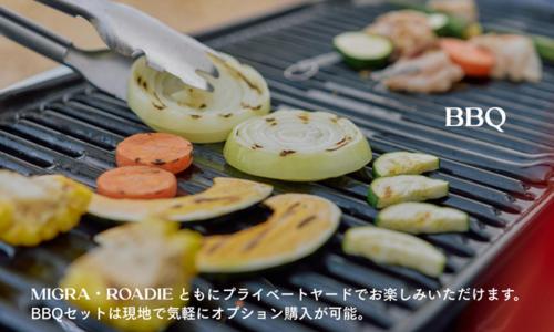 a grill with vegetables and a knife on it at YADOKARI Village 北軽井沢 in Kita-karuizawa
