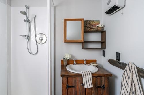 a bathroom with a sink and a mirror at Stone Street Cottage by Sothebys Luxury Rental Homes in Wanaka