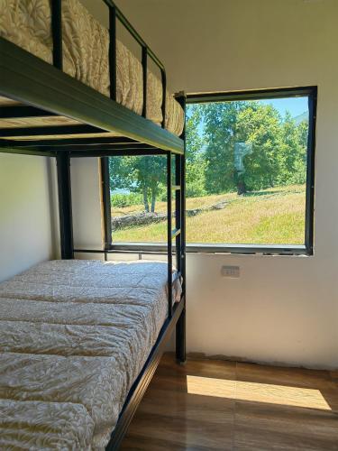 a bedroom with a bunk bed and a large window at Cabaña7 in Neltume