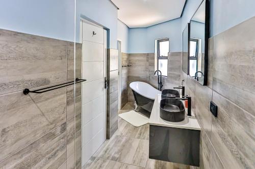 a bathroom with a sink and a mirror at Villa Belle Mere Boutique Hotel in Sheffield Beach
