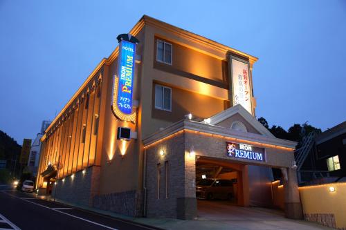 a building with a sign on the side of it at ホテル アイアンプレミアム 六甲店 Adult only男塾ホテルグループ in Kobe