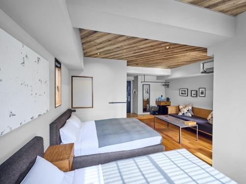 a bedroom with a bed and a living room at Hotel Vintage Tokyo Tsukiji in Tokyo