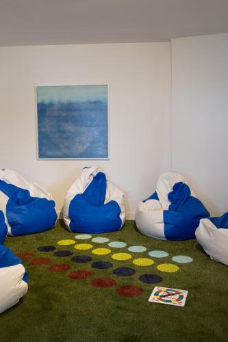 a room with blue and white bean chairs on a carpet at Summercamp in Oak Bluffs