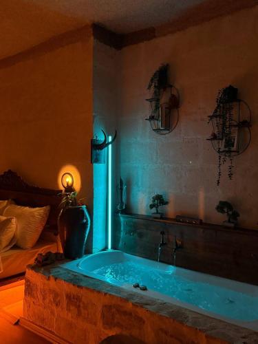 a bathroom with a tub in a room with at İnaros Hotel in Mardin