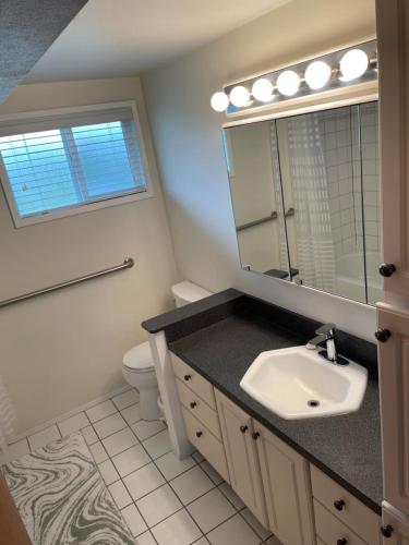 a bathroom with a sink and a mirror at A-town MSM Charmer in Anacortes
