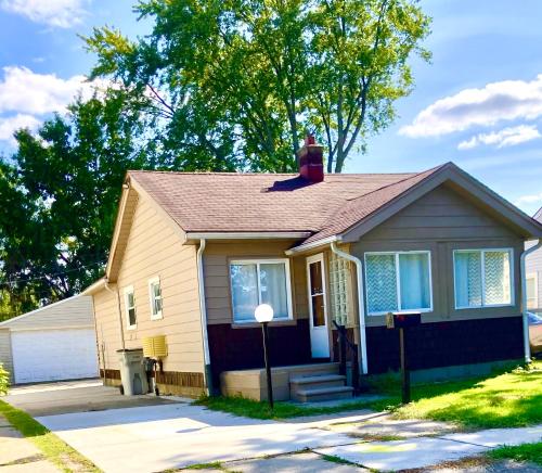 a small house with a red chimney on the roof at Annabelle in Hazel Park