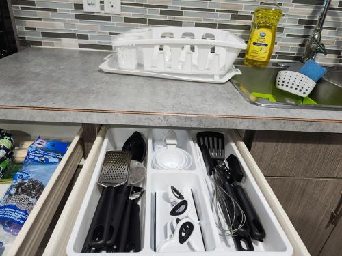 a kitchen drawer filled with utensils on a counter at Stromberg Court in Saskatoon