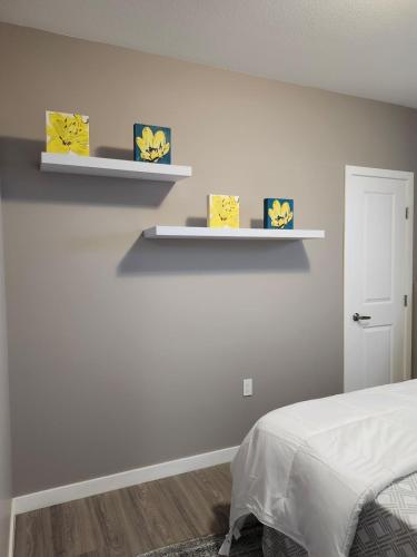 a bedroom with two shelves on the wall at Stromberg Court in Saskatoon