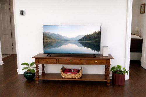 a flat screen tv on a table in a living room at Annabelle in Hazel Park