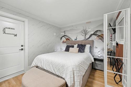 a small bedroom with a bed and a closet at Secluded Bachelor Suite in Vancouver