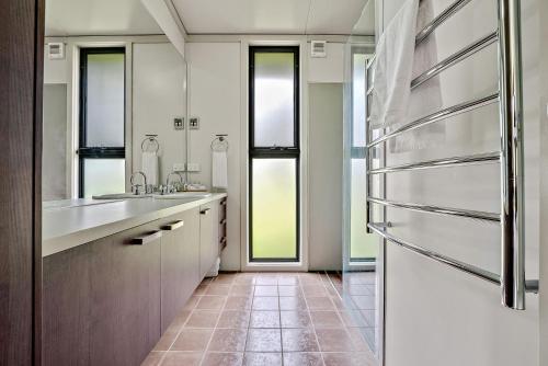 a kitchen with a sink and a refrigerator at Ecocrackenback 13 Sustainable chalet. Stay 3, Pay 2 Summer 2026 in Crackenback