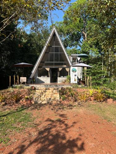 a building with a pointed roof with a sign in front at A-Frame Cottage in Krabi