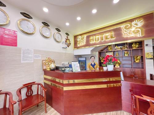 a restaurant with a counter and plates on the wall at Phong Dung Beach Hotel Phan Ri Cua in Tuy Phong