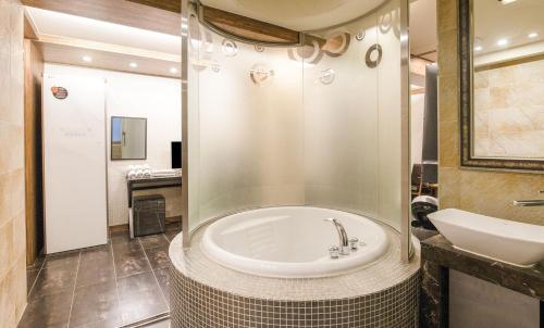 a bathroom with a tub and a sink at Hip Hotel in Seoul