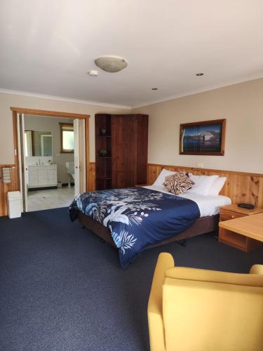 a bedroom with a large bed and a desk at Kentish Hills Retreat in Sheffield