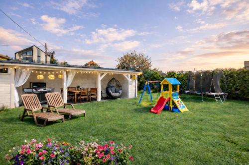 a backyard with a playground and a play set at Villa Martii - Pokoje Rodzinne z Aneksami in Władysławowo
