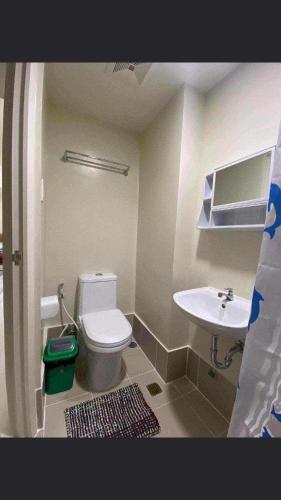 a bathroom with a toilet and a sink at Brenthill Condo Ruby unit in Baguio