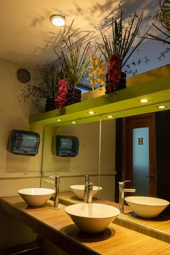 a bathroom with three sinks in front of a mirror at Hotel Gilfer Puebla Centro Histórico in Puebla