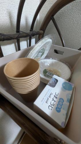 a shelf with bowls and plates and a box on it at 牟礼ぐらし宿 in Takamatsu