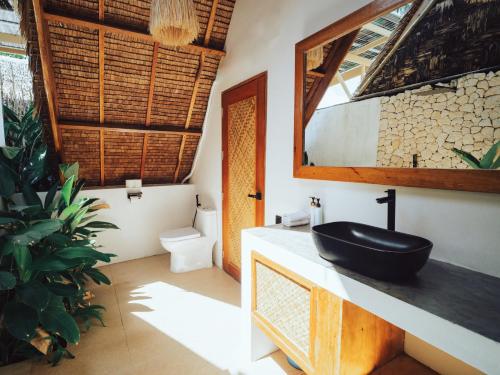a bathroom with a black sink on a counter at Vibes Villas Siargao in General Luna