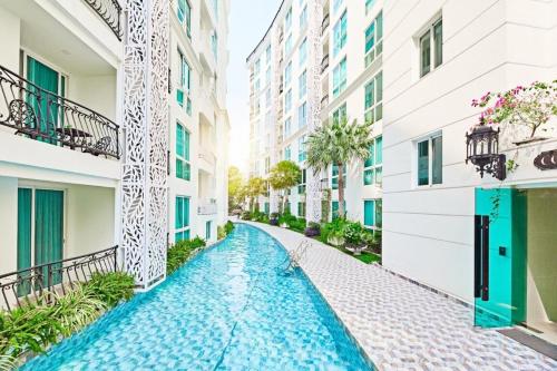 a street in a building with a pool between two buildings at City Garden Lagoon Pool Apartments with Balcony Pattaya in Pattaya South