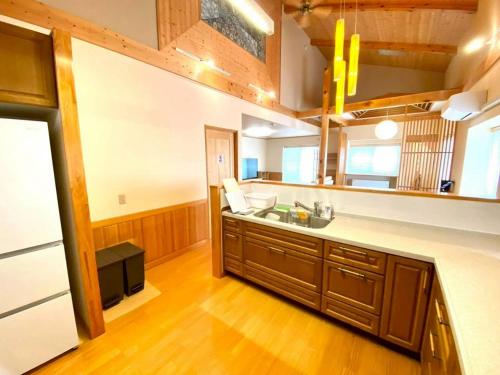 a large kitchen with a sink and a stove at Luxury Villa N and N in Aomori