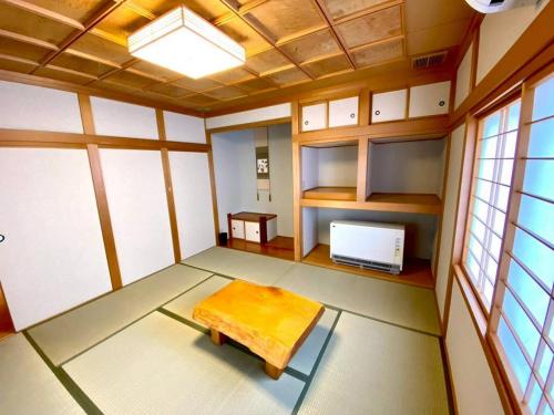 an empty room with a table and a tv at Luxury Villa N and N in Aomori