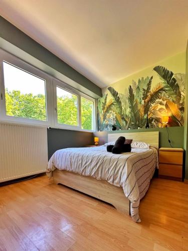 a bedroom with a bed with a black cat laying on it at Duplex with Jacuzzi and parking Close to Disney in Lognes