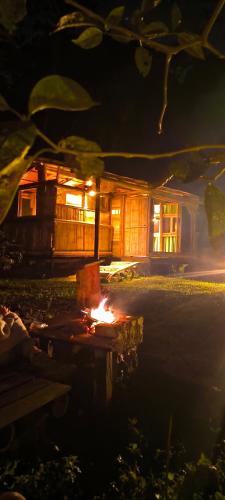 a fire pit in front of a house at night at Monte La MaMa Ecolodge in Viotá