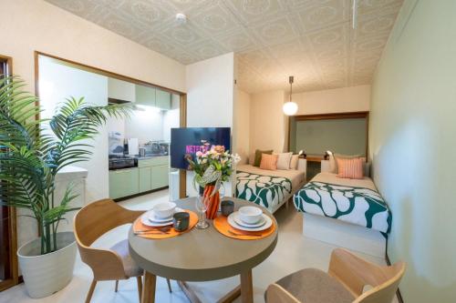 a living room with a table and chairs and a bedroom at 森 BREEZE furano MORI in Furano