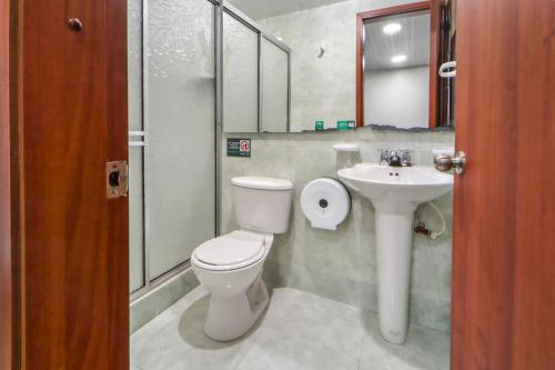 a bathroom with a toilet and a sink at Casa Magi in Bogotá
