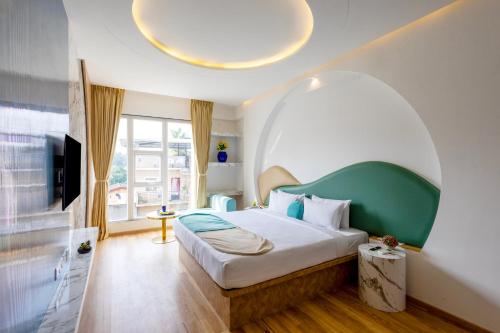 a bedroom with a bed with an arched ceiling at Palette The Moon Hotel by CheckIn, Goa in Goa
