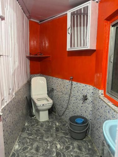 a small bathroom with a toilet and a sink at Blue Valley Escape in Darjeeling