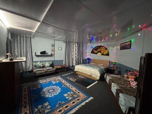 a bedroom with a tent with a bed and a couch at Blue Valley Escape in Darjeeling