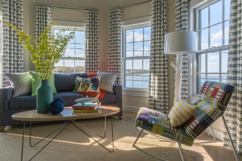 a living room with a couch and a table at Summercamp in Oak Bluffs